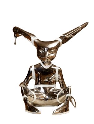 statue of a woman sitting on a chair with a knife in her hand