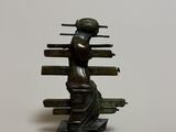 bronze statue of a woman holding a book on a white background