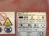 a close up of a red gas tank with a sticker on it