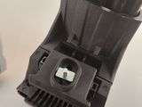a close up of a black object on a white table