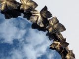 a mirror that has a bunch of leaves on it