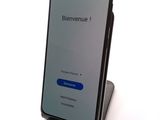 an image of a cell phone with a blue button on the screen