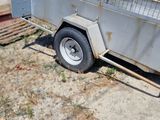 a trailer with a cage on the back of it