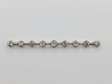 a diamond bar broocht on a white background