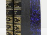 a pair of black and blue books sitting on top of each other