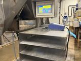 an image of a machine in a factory with a conveyor belt