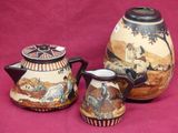 three vases with different designs on them on a pink background