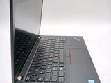 a black laptop with a red button on the keyboard