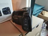 a black camera sitting on top of a cardboard box