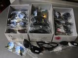 three boxes of assorted items sitting on a table