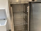 two refrigerators that are next to each other in a room