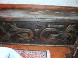 a wooden chest with a dragon design on it