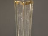 a clear glass vase with a gold rim sitting on a table