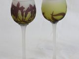 two wine glasses with horses on them on a white background