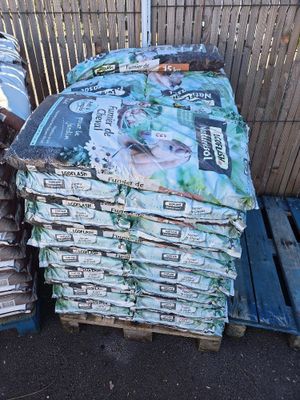 many bags of food sitting on top of pallets