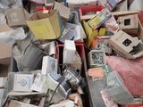 a pile of assorted electronic devices in a bin