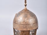 a close up of a metal helmet with a chain around it