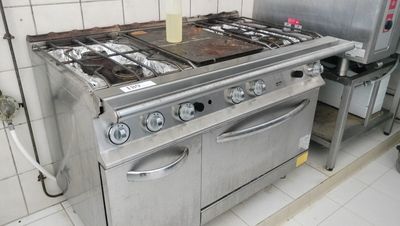 a kitchen with a stove, oven, and sink in it