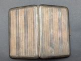 an old silver cigarette case sitting on top of a table