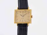 a close up of a watch on a black strap on a white background