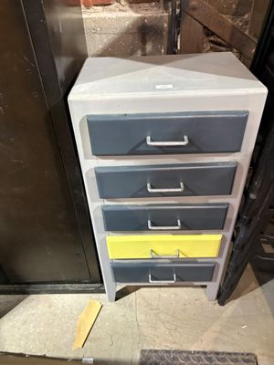 a stack of drawers sitting on the floor next to a door