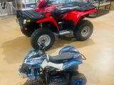 two atvs that are on display in a showroom