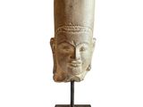 an image of a stone head on a stand with a white background