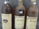 three bottles of wine sitting next to each other on a table