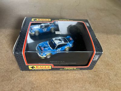 a box with two toy cars in it on the floor