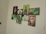 a wall with pictures of buddhas and flowers on it