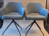 two chairs that are sitting next to each other