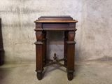 a small wooden table with a book on top of it
