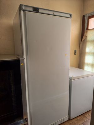 a white refrigerator in the corner of a room