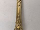 an antique gold plated knife on a white background