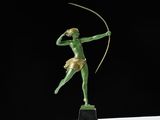 a bronze statue of a woman holding a bow and arrow
