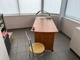 a desk and a chair in a room with a window