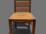 an image of a wooden chair with a wicker seat on a gray background