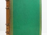 a green book sitting on top of a white table