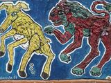 a painting of two dogs playing with a ball