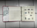 an open book with stamps on it sitting on a tiled floor