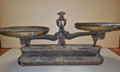 a metal scale with two bowls on it on a table
