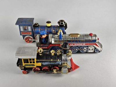 a toy train that is sitting next to another toy train