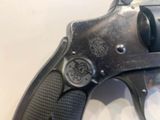 a close up of a gun on a white surface