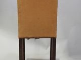an image of a chair with a piece of cardboard on the back of it