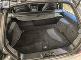 the back of a car with its trunk open and the seats down