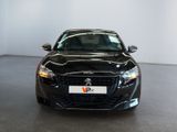 the front of a black car is parked in a showroom
