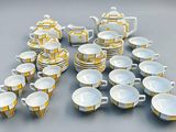 many cups and saucers that are sitting on the table