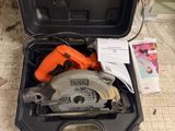 an open tool box with a circular saw in it on the floor