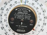 a close up of a clock on a white surface
