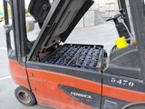 a fork lift truck with the door open on the street